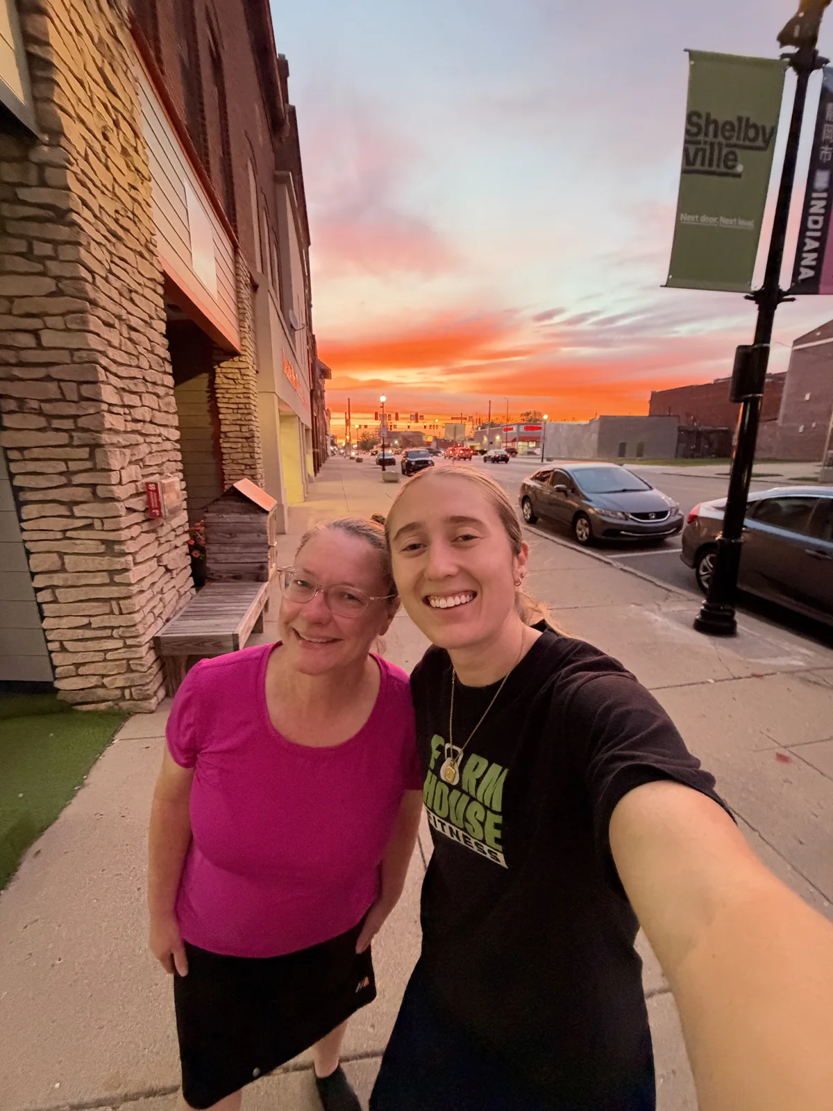 Two people smiling outside in Shelbyville at sunset