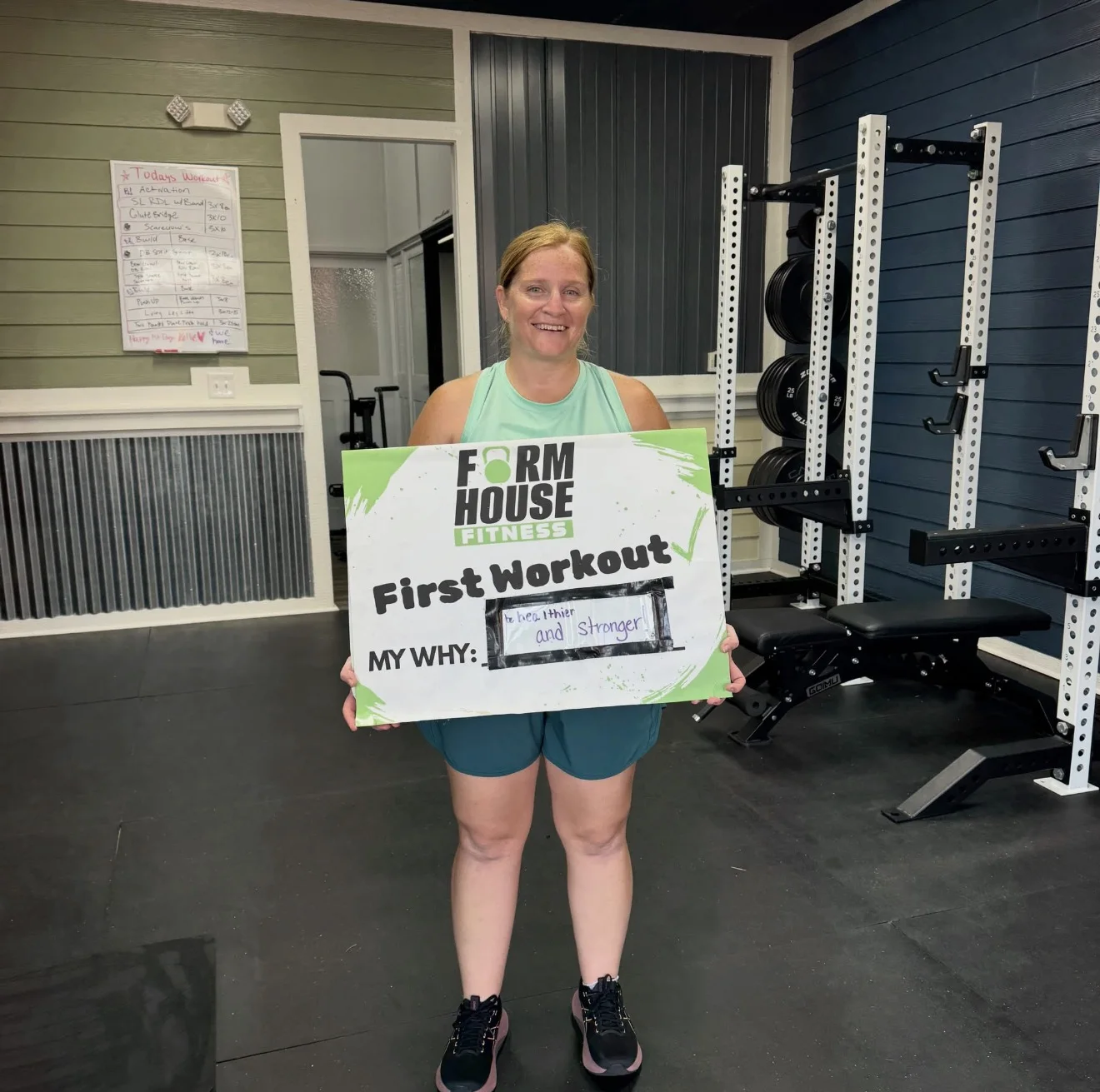A smiling Formhouse member celebrating her first workout