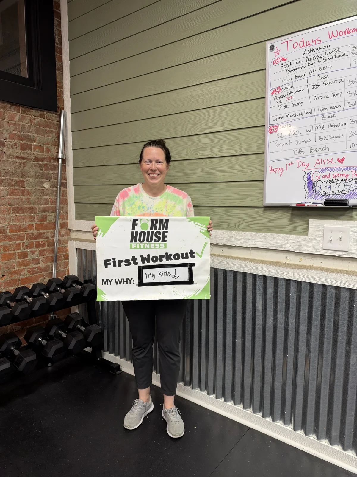 A Formhouse participant celebrating their first workout with a personal goal sign