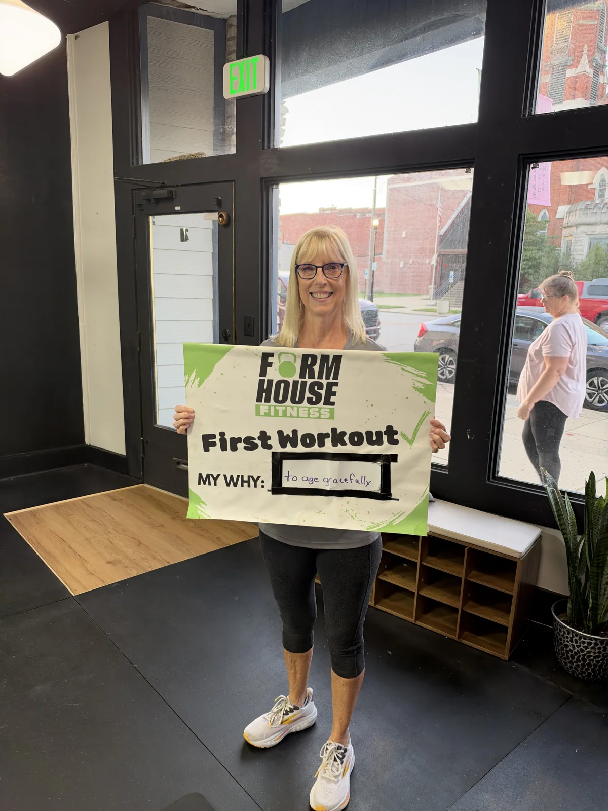 A Formhouse participant celebrating their first workout with a personal goal sign