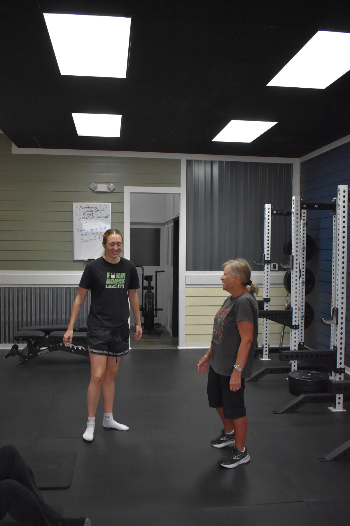 A Formhouse coach and member smiling together on the training floor