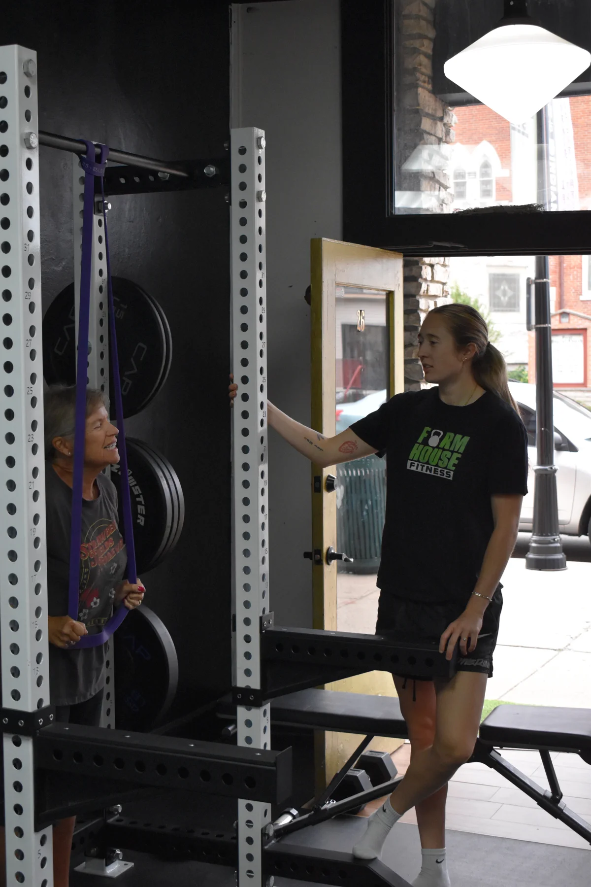 A Formhouse coach talking with a member beside the training equipment